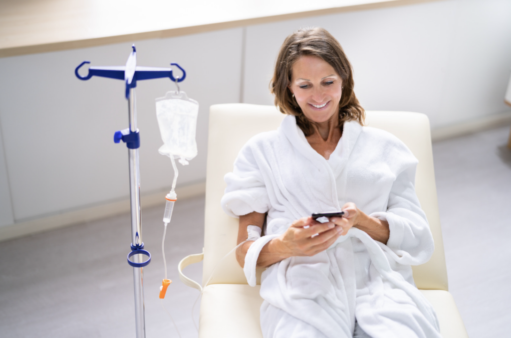 Women relaxing in robe while getting IV therapy