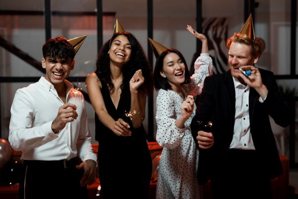 friends holding sparklers new year s eve party