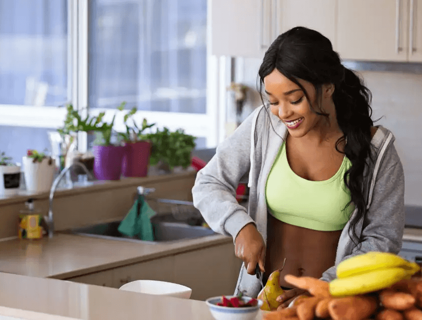 healthy woman cutting up produce